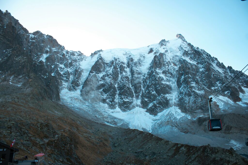 Explore the majestic snow-capped Mont Blanc Massif with a cable car view in Chamonix, France.